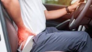 Man With Back Sprain While Driving Car