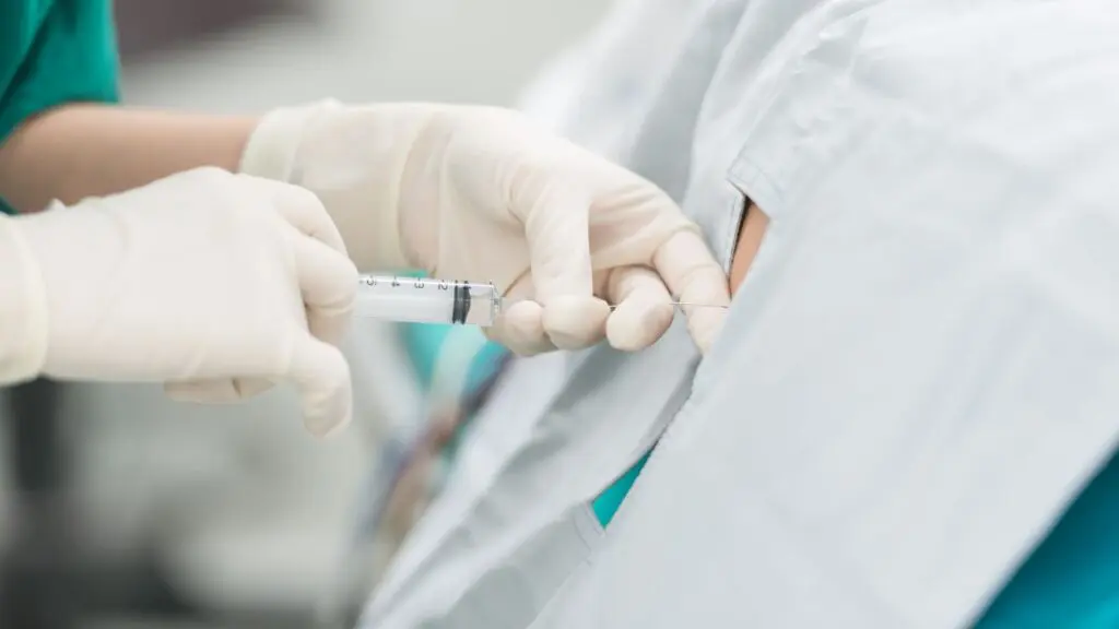 A Doctor Injecting Injection To A Patient