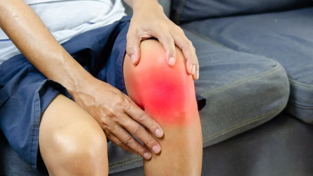 A Person Holding A Knee In Pain