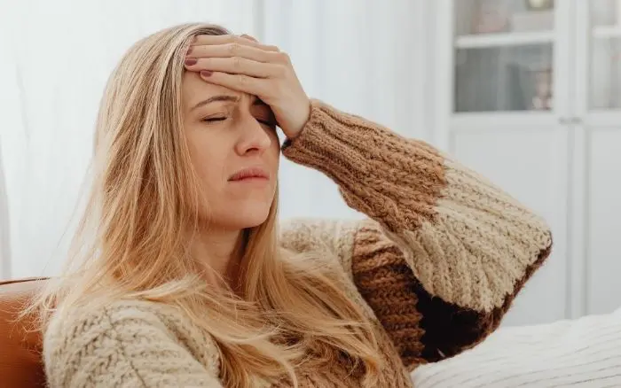 Woman Holding Head In Pain